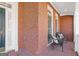Inviting covered porch with brick flooring and seating area at 3967 Bellingrath Main Nw, Kennesaw, GA 30144