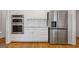 Bright kitchen with stainless steel appliances, including a refrigerator and double oven, and white cabinetry at 3967 Bellingrath Main Nw, Kennesaw, GA 30144