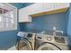 A dedicated laundry room features side-by-side stainless steel washer and dryer beneath white upper cabinets at 3967 Bellingrath Main Nw, Kennesaw, GA 30144