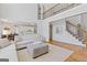 Spacious living room with hardwood floors, open layout, and staircase with black wrought iron spindles at 3967 Bellingrath Main Nw, Kennesaw, GA 30144