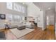 Inviting living room featuring two story windows, sleek hardwood floors, and an open layout at 3967 Bellingrath Main Nw, Kennesaw, GA 30144