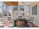 Screened-in patio with ceiling fan, wood floors, and an outdoor dining set for relaxing and entertaining at 3967 Bellingrath Main Nw, Kennesaw, GA 30144