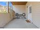 Covered patio with seating for two, providing an intimate outdoor space adjacent to the home at 3967 Bellingrath Main Nw, Kennesaw, GA 30144