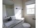 Bathroom featuring a granite countertop vanity, framed mirror, and brushed bronze fixtures at 263 Banberry Se Dr, Atlanta, GA 30315