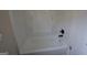 This bathtub features a tub and shower combination with wall shelves and brushed bronze fixtures at 263 Banberry Se Dr, Atlanta, GA 30315