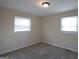 This bedroom features neutral walls, carpeted floors, and natural light from two windows at 263 Banberry Se Dr, Atlanta, GA 30315