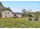 View of backyard featuring a patio furniture set, shed, and the home's exterior at 71 Russell Rd, Mcdonough, GA 30252