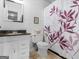 Cozy bathroom with vanity, toilet, and shower with decorative shower curtain at 71 Russell Rd, Mcdonough, GA 30252