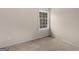 Bright bedroom with neutral carpet, fresh paint, and a window offering natural light at 71 Russell Rd, Mcdonough, GA 30252