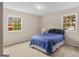 Bedroom featuring two windows, carpet, and bed at 71 Russell Rd, Mcdonough, GA 30252