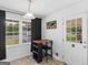 Bright dining area featuring a large window with curtains and a door to the exterior at 71 Russell Rd, Mcdonough, GA 30252