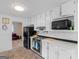 Bright kitchen with white cabinets, a black refrigerator and a view into the living room at 71 Russell Rd, Mcdonough, GA 30252