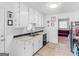 Kitchen features white cabinets and a view into the adjacent living room at 71 Russell Rd, Mcdonough, GA 30252