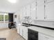 Bright kitchen with white cabinets, tiled backsplash, a double sink, and ample counter space at 71 Russell Rd, Mcdonough, GA 30252