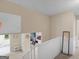 Second floor landing featuring neutral paint, carpeting, and a view to downstairs at 71 Russell Rd, Mcdonough, GA 30252