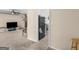 Open-concept living room with carpet, view into a kitchen, and a black refrigerator at 71 Russell Rd, Mcdonough, GA 30252