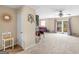 Spacious carpeted living room with adjacent sitting area, view of a patio, and natural light at 71 Russell Rd, Mcdonough, GA 30252