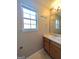Bathroom with a window, a single sink vanity, and a large mirror at 159 Courtneys Ln, Fayetteville, GA 30215