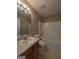 Bathroom featuring a shower and tub combo and wooden sink vanity at 159 Courtneys Ln, Fayetteville, GA 30215