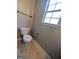Bathroom featuring a toilet and a window providing natural light at 159 Courtneys Ln, Fayetteville, GA 30215