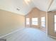 Carpeted bedroom with neutral walls, a vaulted ceiling and bright windows at 159 Courtneys Ln, Fayetteville, GA 30215