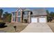 Charming brick home featuring a two-car garage and a well-maintained front yard at 159 Courtneys Ln, Fayetteville, GA 30215