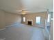 Spacious living room featuring carpet, a ceiling fan, and a fireplace with a mantel at 159 Courtneys Ln, Fayetteville, GA 30215