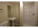 Functional bathroom with a pedestal sink and a walk-in shower at 3122 Latona Sw Dr, Atlanta, GA 30354