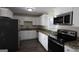 Modern kitchen featuring stainless steel appliances, granite countertops, and white cabinetry at 3122 Latona Sw Dr, Atlanta, GA 30354