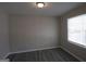 A bright and airy bedroom with gray walls, modern flooring and a bright window at 619 Church Nw St, Atlanta, GA 30318