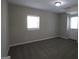 Basement area featuring neutral walls, cozy carpeting, and a door leading to the outside at 619 Church Nw St, Atlanta, GA 30318
