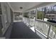 View of the covered front porch featuring a white railing and concrete flooring at 619 Church Nw St, Atlanta, GA 30318