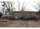 Rear exterior with deck offers access to yard and displays classic brick and stone foundation at 1923 Rosewood Rd, Decatur, GA 30032