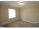 Comfortable bedroom with plush carpeting, a large window, and freshly painted walls at 1923 Rosewood Rd, Decatur, GA 30032