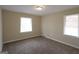 Comfortable bedroom with plush carpeting and natural light from two windows at 1923 Rosewood Rd, Decatur, GA 30032
