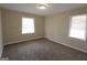 Cozy bedroom with plush carpeting and natural light from two windows at 1923 Rosewood Rd, Decatur, GA 30032