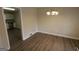 Open dining room features modern chandelier, hardwood floors and flows into kitchen space at 1923 Rosewood Rd, Decatur, GA 30032