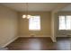 Bright dining room featuring updated flooring, a stylish chandelier, and abundant natural light at 1923 Rosewood Rd, Decatur, GA 30032