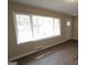 Bright living room featuring laminate flooring, ample natural light and an exterior door at 1923 Rosewood Rd, Decatur, GA 30032