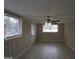 Spacious living room featuring tile floors, wainscoting, natural light and a ceiling fan at 1923 Rosewood Rd, Decatur, GA 30032