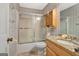 Bathroom featuring a tiled shower with glass door, toilet, and vanity with granite countertop at 110 Sycamore Bnd, Fayetteville, GA 30214