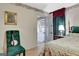 Cozy bedroom featuring floral accents, soft lighting, and access to the sunroom at 110 Sycamore Bnd, Fayetteville, GA 30214