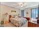 Cozy bedroom with a bed, lamps, chest, neutral walls, ceiling fan, and ample natural light at 110 Sycamore Bnd, Fayetteville, GA 30214