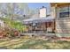 Backyard exterior featuring mature landscaping and sunroom with glass ceiling at 110 Sycamore Bnd, Fayetteville, GA 30214