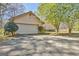 Attached two car garage with a concrete driveway and mature landscaping at 110 Sycamore Bnd, Fayetteville, GA 30214