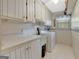 Laundry room equipped with a utility sink, cabinets, and a washer and dryer at 110 Sycamore Bnd, Fayetteville, GA 30214