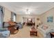 Cozy living room with floral sofa, organ, and adjacent dining area at 110 Sycamore Bnd, Fayetteville, GA 30214