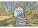 Backyard shed featuring a light blue door and wooden ramp at 110 Sycamore Bnd, Fayetteville, GA 30214