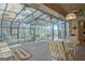 Glass ceiling sunroom featuring multiple seating areas and beautiful backyard view at 110 Sycamore Bnd, Fayetteville, GA 30214