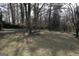 Lush backyard showcasing an expansive lawn and beautiful mature trees at 2509 Appomattox Dr, Decatur, GA 30034